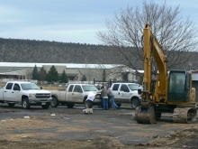 Image: Construction workers review the plans at the site of the new computer lea