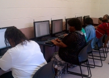 A group of students use computers to learn digital literacy skills