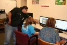 A TDV instructor helps two students navigate the Internet